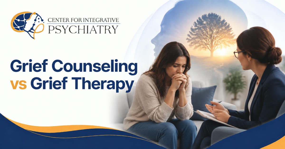 Grieving woman with clasped hands speaking with a counselor taking notes in a calm therapy room