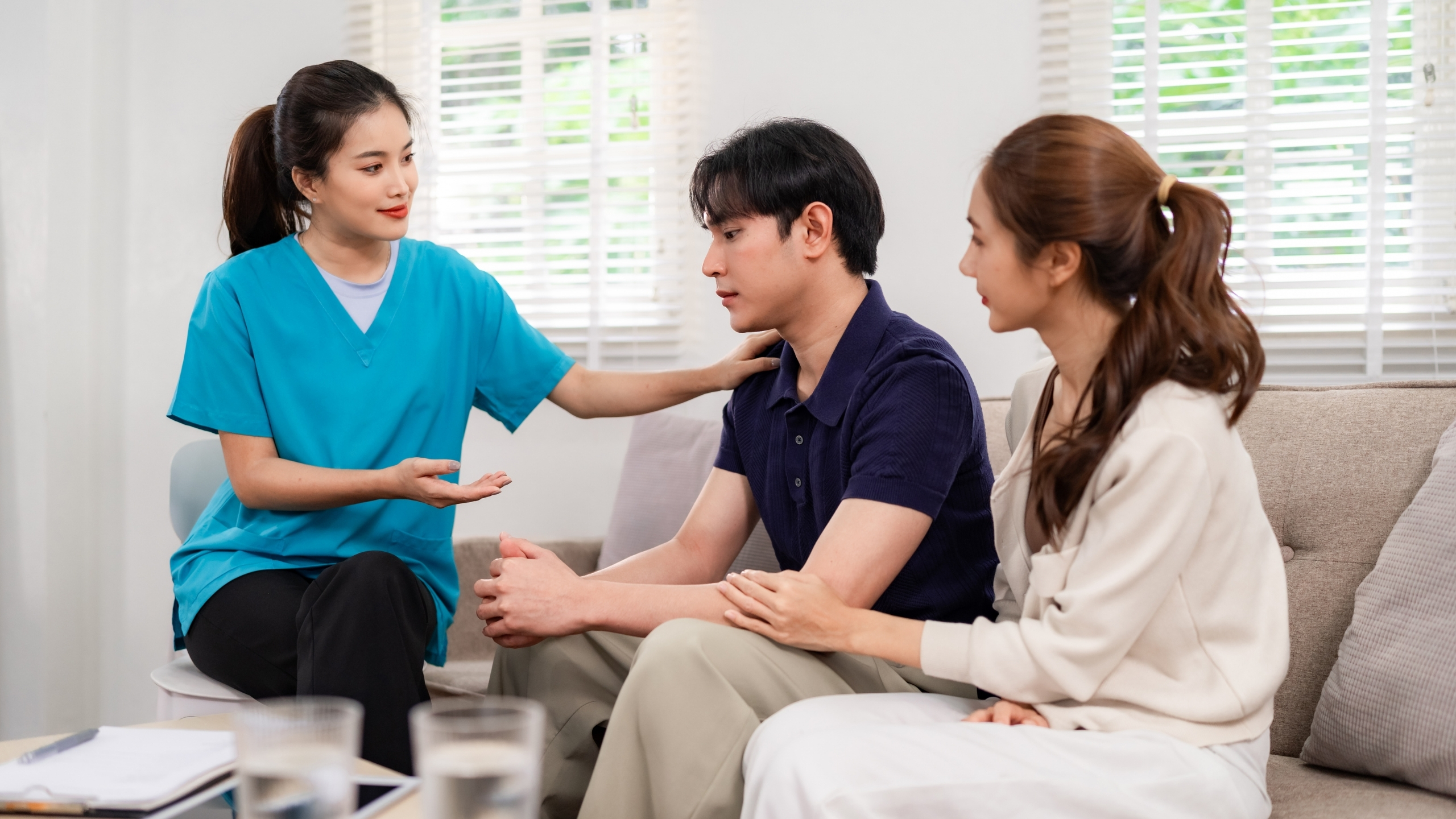 A couple discussing their feelings with a therapist in a comfortable therapy room, emphasizing communication and support.