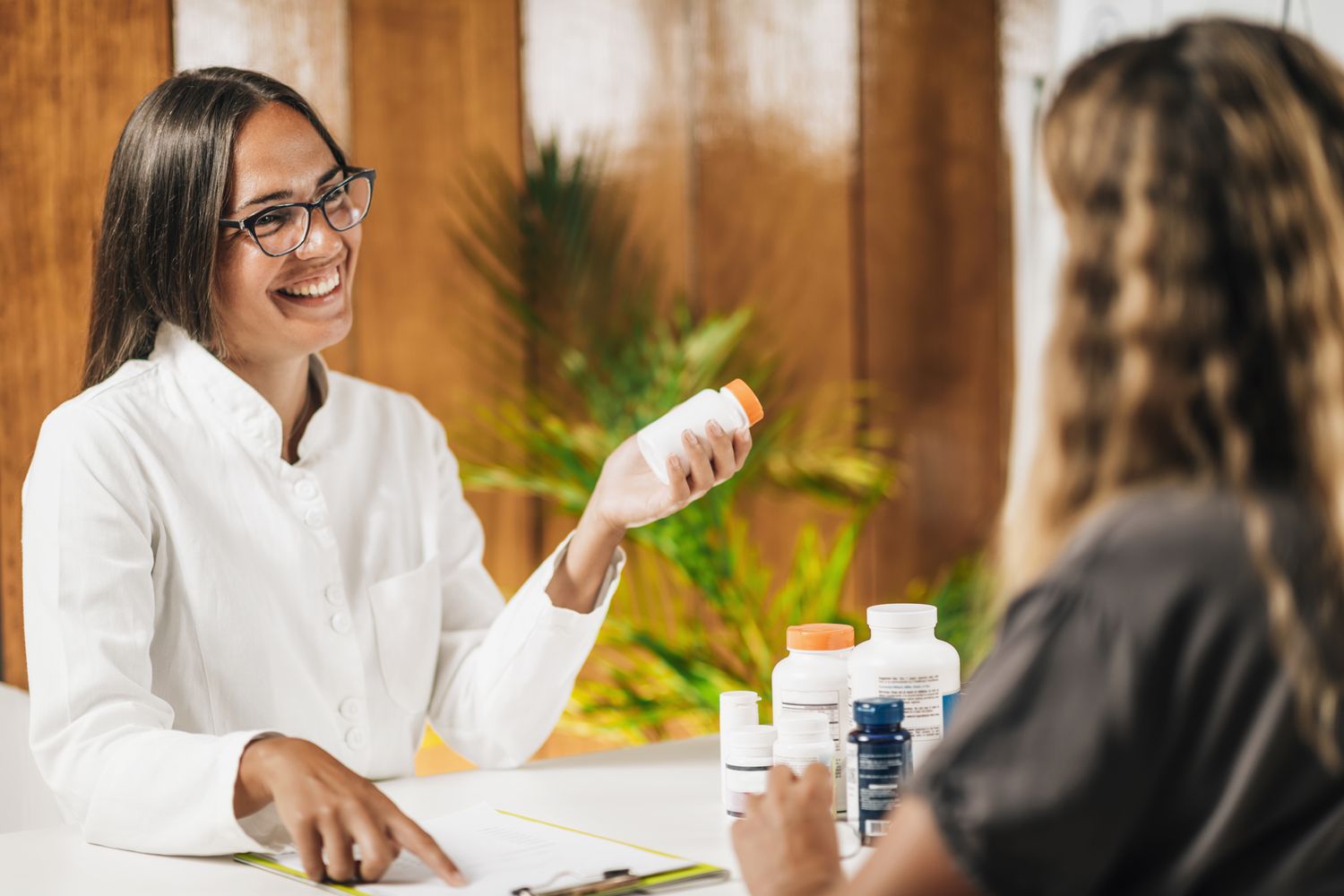 A practitioner reviewing a patient's supplements and herbs