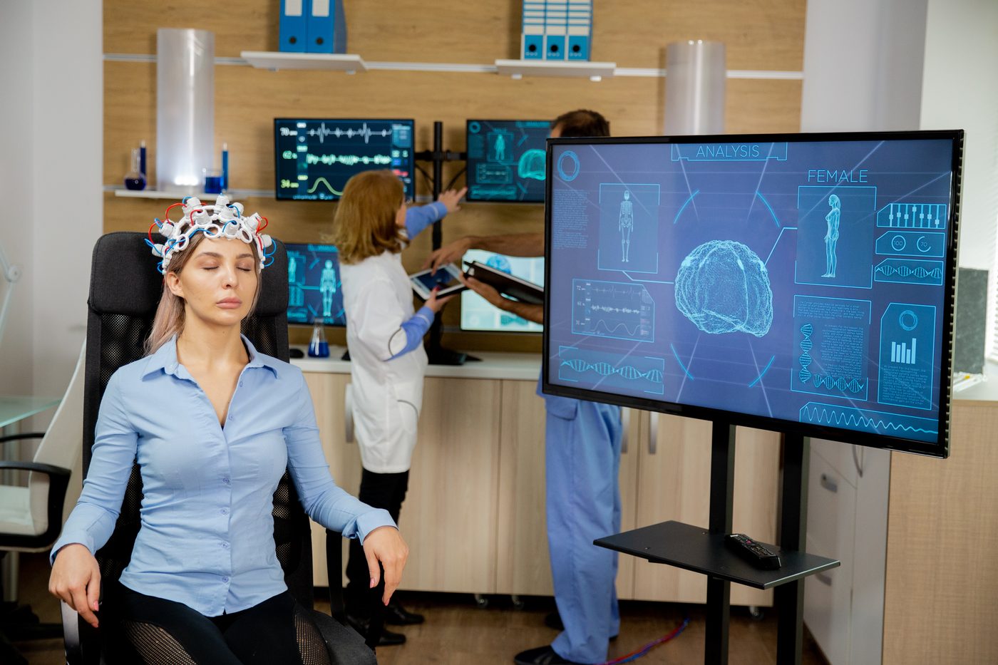 A person wearing EEG sensors responding to a feedback screen